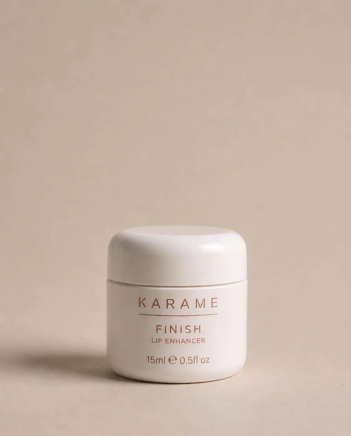 KARAME FINISH Lip Enhancer closed jar on a cream background