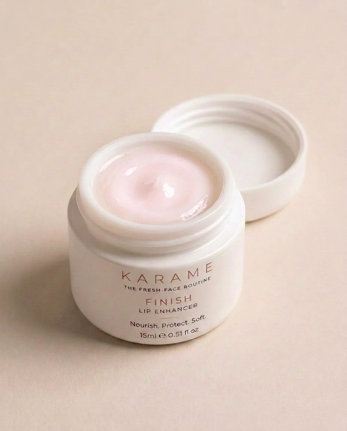 KARAME FINISH Lip Enhancer open jar showing the creamy balm, on a cream background